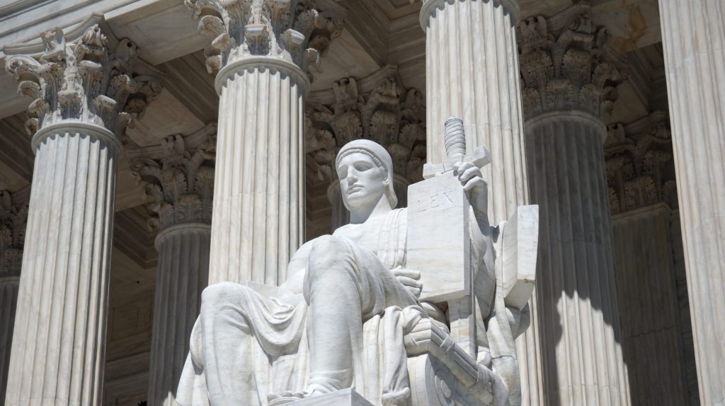 Image of the marble statue of the Guardian or Authority of Law in front of the Supreme Court in Washington DC.